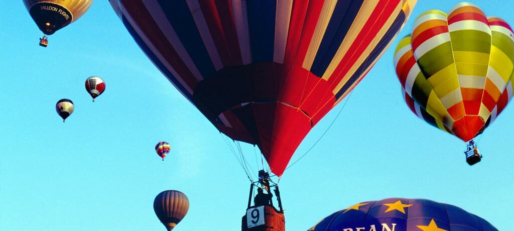 hot air balloons up in a blue sky