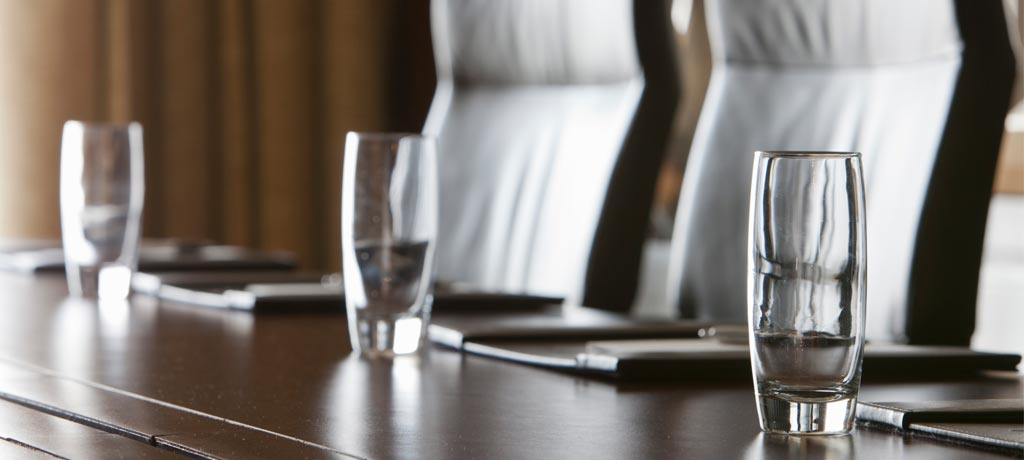 Boardroom view of table, water glasses and chairs